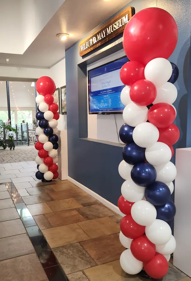 Red, white, and navy balloon columns at the Wilbur D. May Museum
